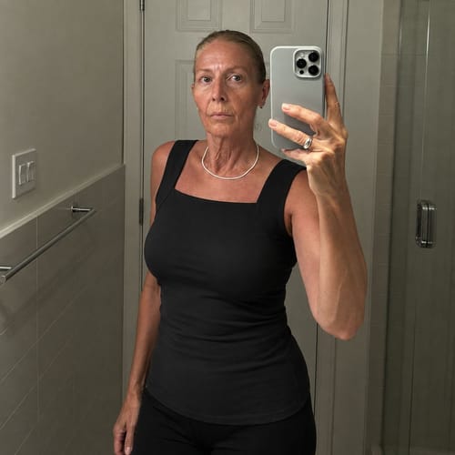 Ayah customer wearing the black Restore Bra Tank in a mirror selfie