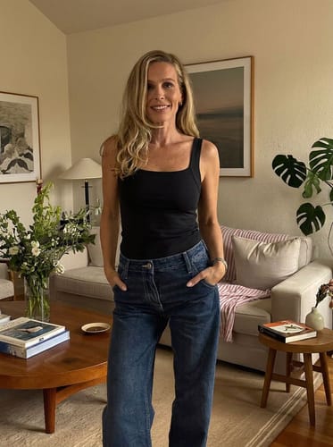 Ayah customer wearing the black Restore Bra Tank with relaxed jeans